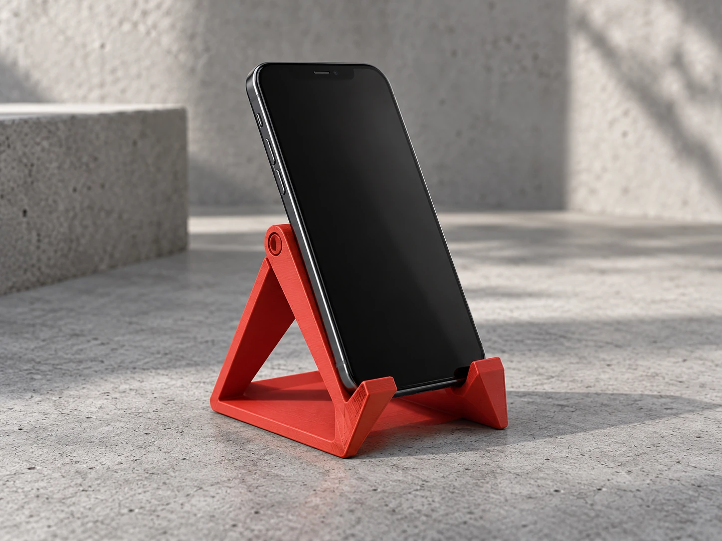 A red geometric stand for your phone.