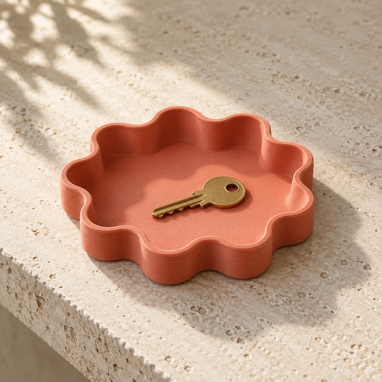 A coral scalloped catchall tray.